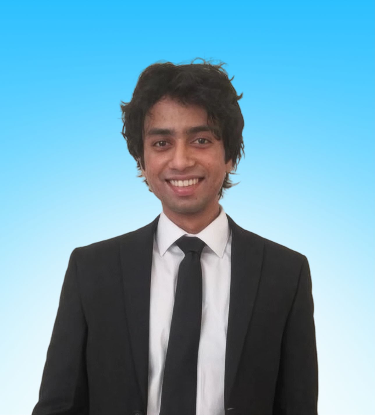 Portrait of Aditya Prakash, founder of Dante Design House, in a dark suit against a light blue background.